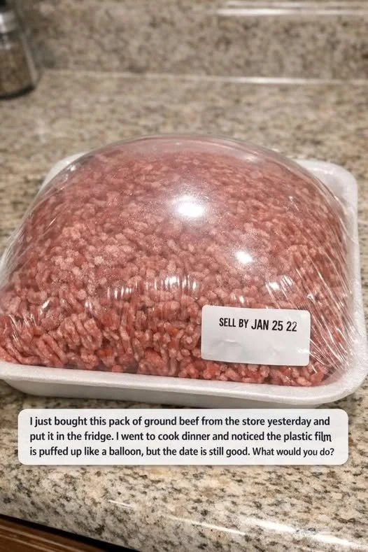 Puffed ground beef packaging in the fridge indicating safety concerns.