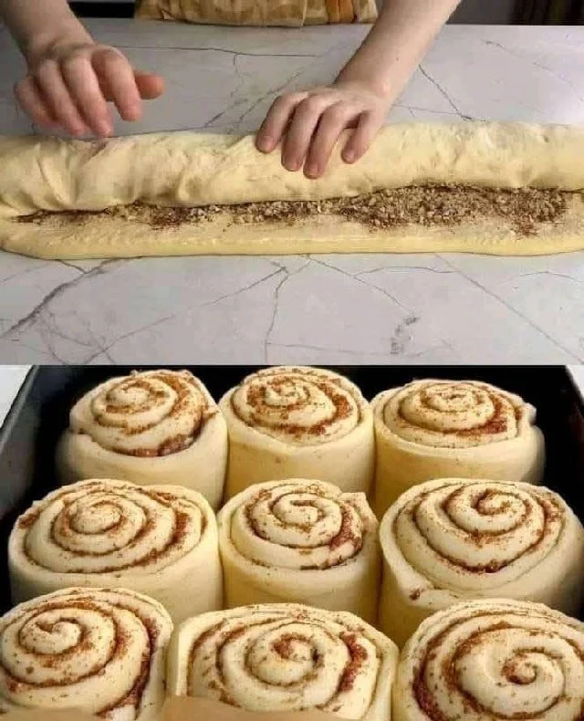 Delicious soft cinnamon-walnut rolls with cream cheese frosting on a plate.