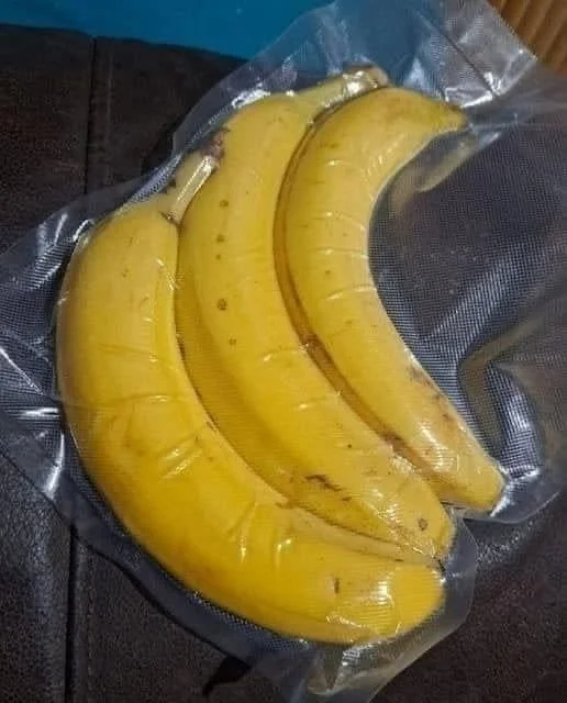 Cutting open vacuum-sealed bananas to reveal their texture and freshness