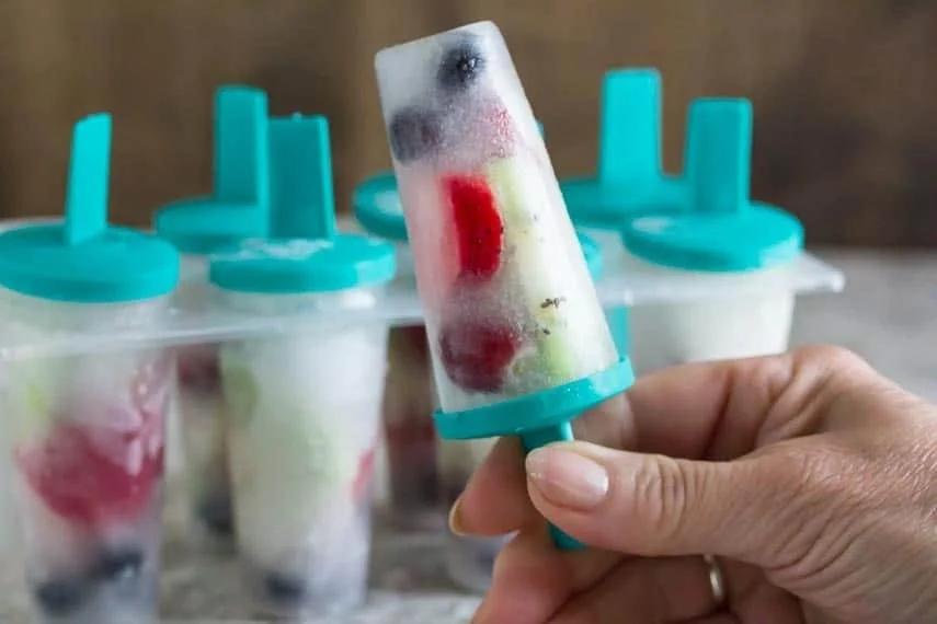 Delicious coconut water popsicles with fresh fruit ready to enjoy