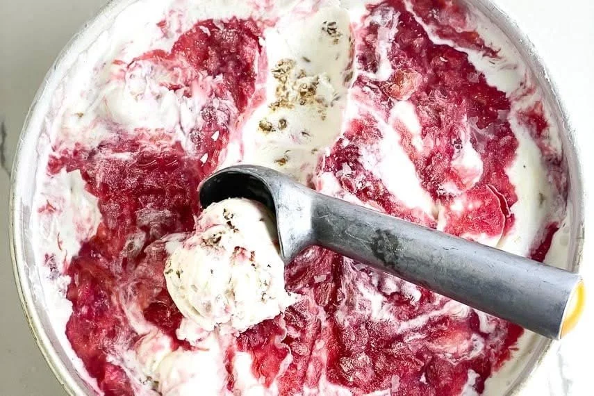 Low FODMAP rhubarb crumble ice cream topped with crumble and fresh rhubarb