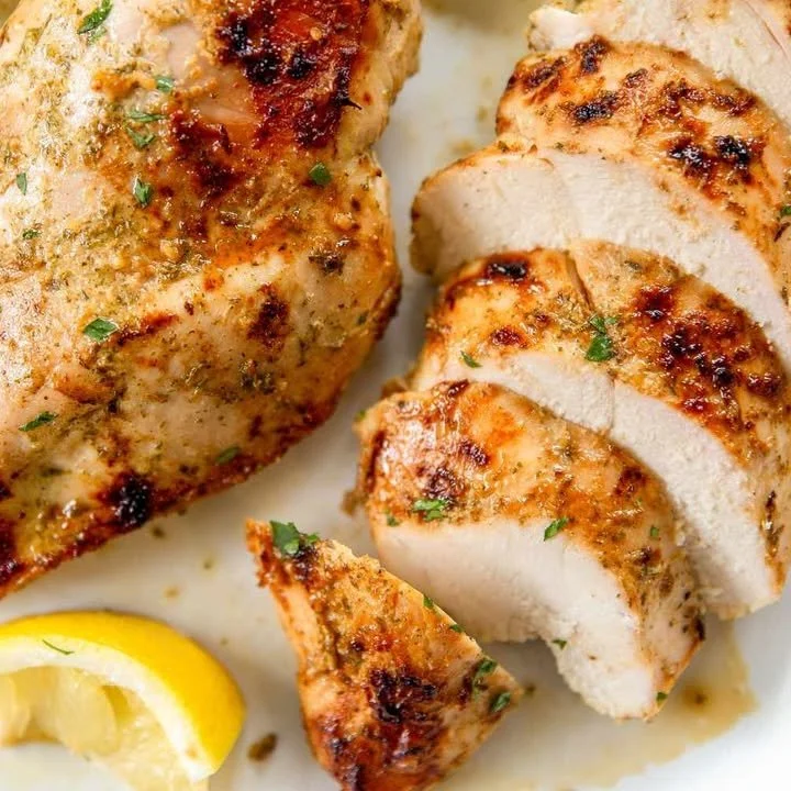 Juicy Citrus-Marinated Chicken Breast garnished with herbs and citrus slices