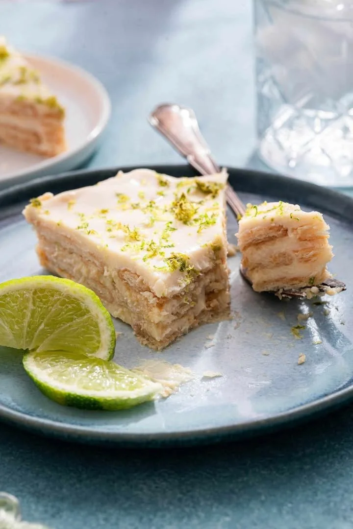 Delicious slice of Key Lime Pie topped with whipped cream and lime zest.