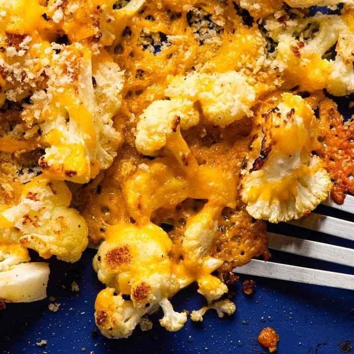 Roasted cauliflower with crispy cheddar and breadcrumbs on a plate