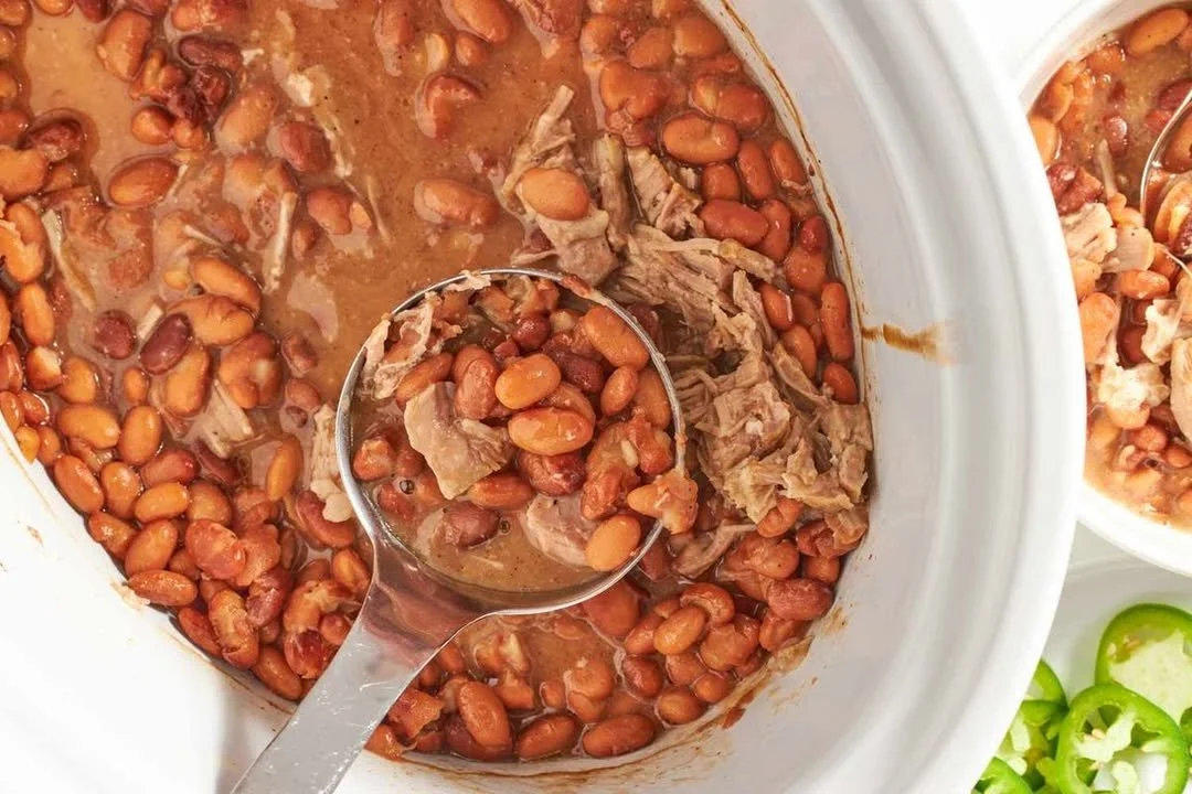Delicious slow-cooked pinto beans in a bowl with herbs.
